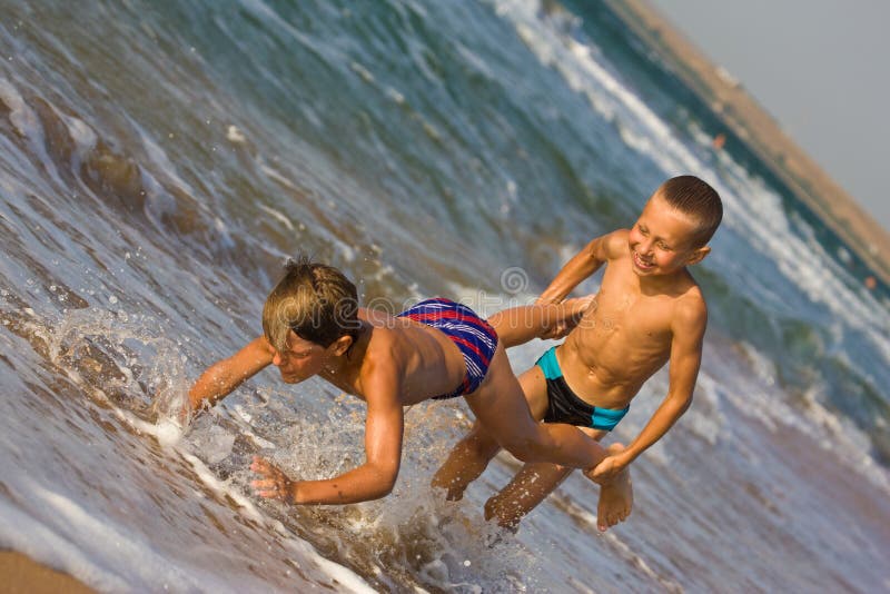 Playful boys enjoying the beach together, Stock Photo, Picture And Royalty  Free Image. Pic. BIM-BLD083548