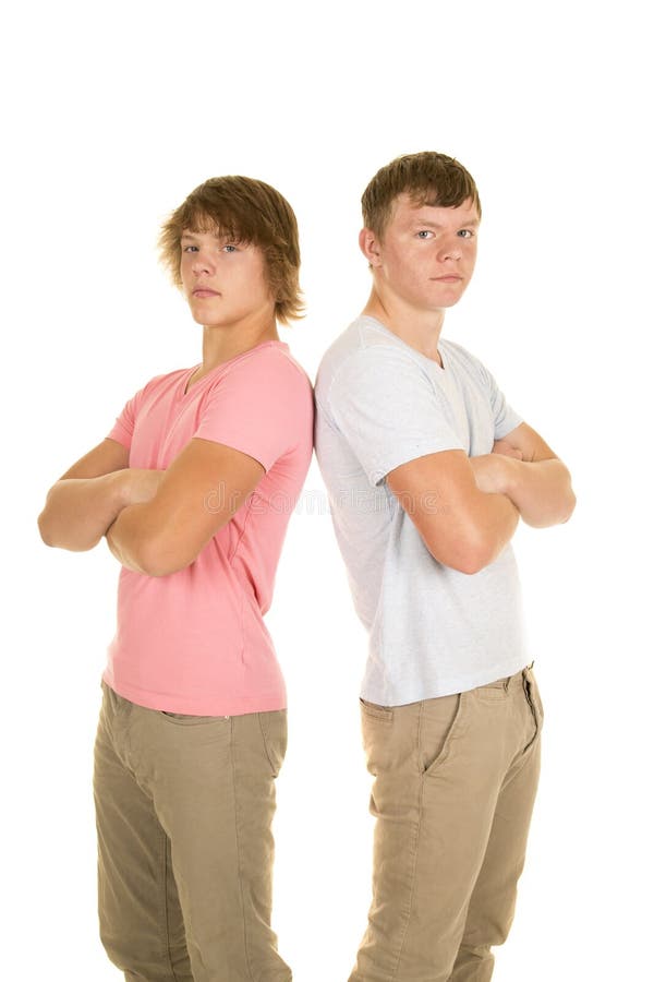 Two boys in colored shirts back to back serious