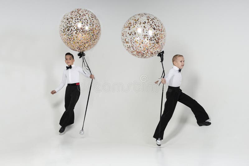 Two Boys Engaged in Ballroom Dancing Pose with Balloons Standing in a