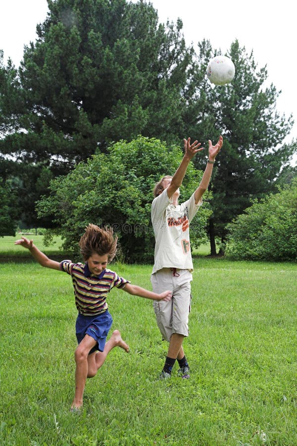 Two boys play with boll