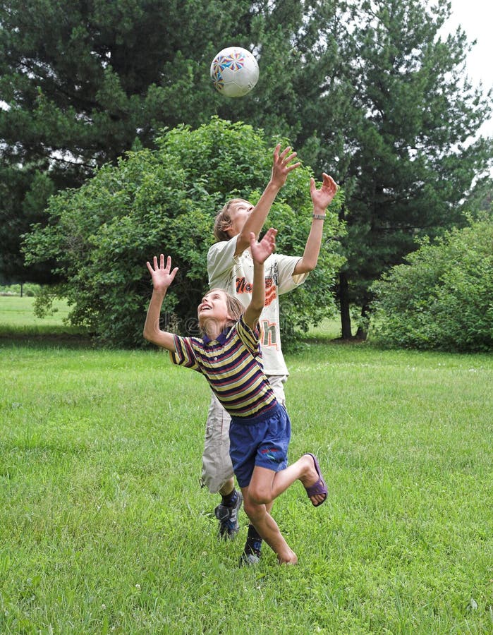 Two boys play with boll