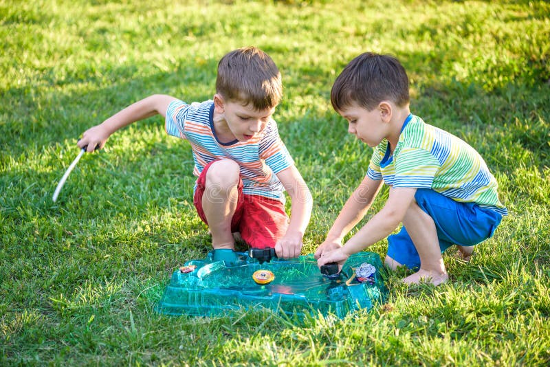 Two Boys Playing with a Beyblade, Spinning Top Kid Toy. Popular Children  Game Tournament. Stock Photo - Image of popular, cartoon: 122435594