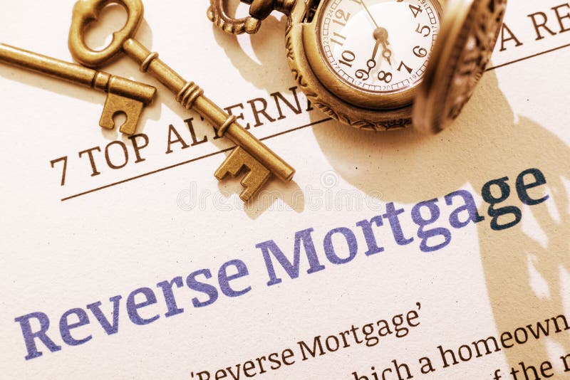 Two brass keys and a pocket watch on a reverse mortgage instruction document. stock photography Two brass keys and a pocket watch on a reverse mortgage instruction document. stock photography