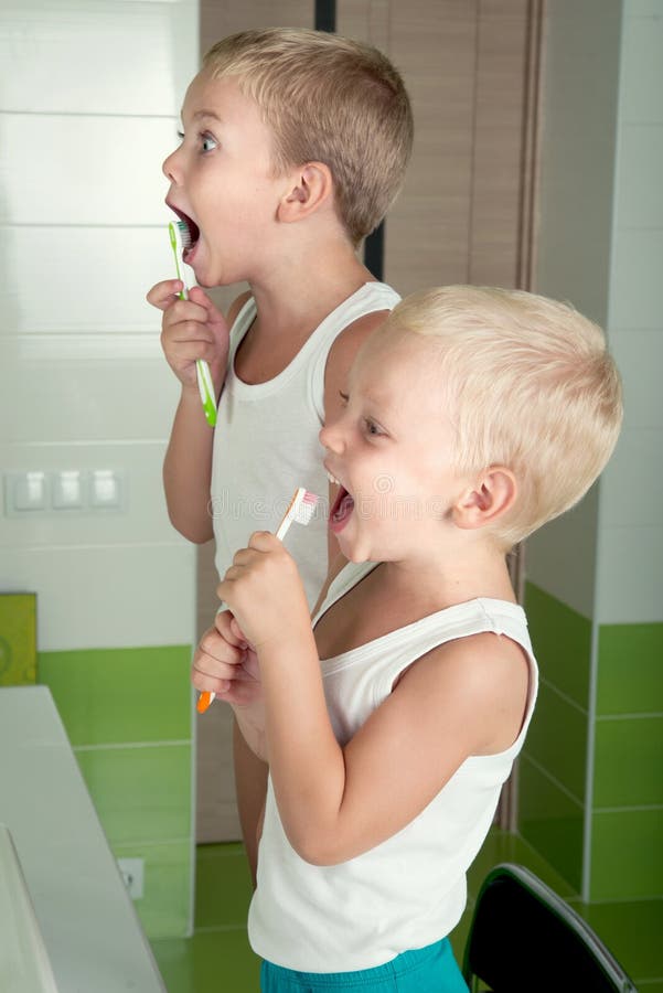 Two brothers brush teeth in the bathroom. royalty free stock image Two brothers brush teeth in the bathroom. royalty free stock image