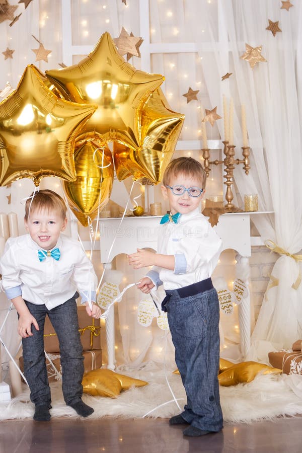 Two brothers in a gold Christmas decorations