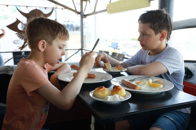 Two Brothers Have Breakfast Stock Photo Image of fork, dinner 251399306