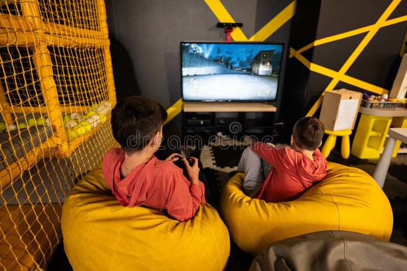 Two brothers playing video games at home. - a Royalty Free Stock Photo from  Photocase