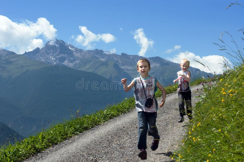 Two brothers running on mountain path