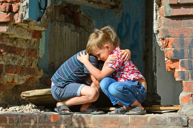 When I Returned Home My Family Was Ruined Two Brothers are Sitting Near the Ruined House. Stock Photo - Image of