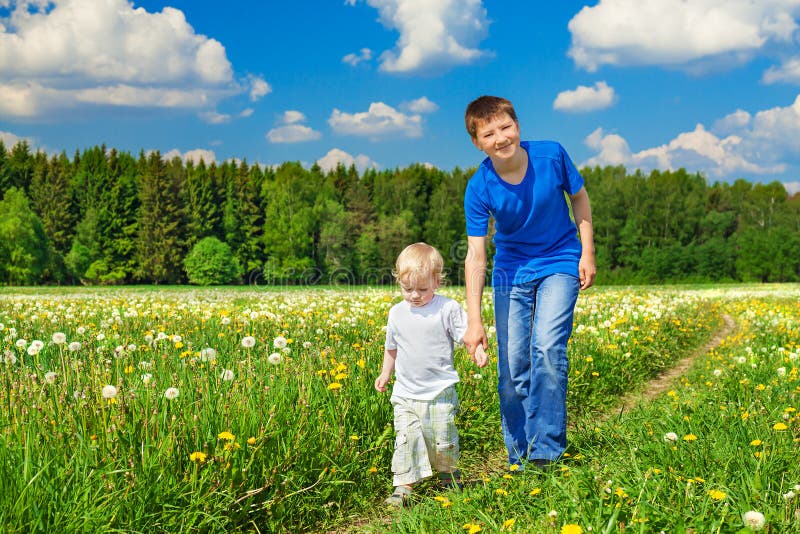 Two brothers, small child and teenager stock image Two brothers, small child and teenager stock image