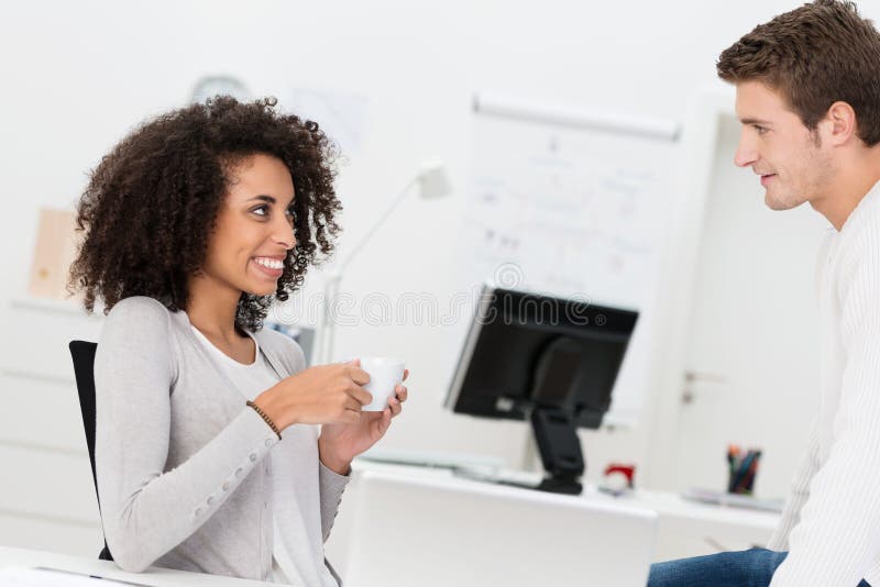Two business colleagues relax over coffee royalty free stock photo