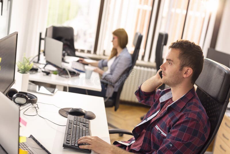 Making a phone call at work stock photos