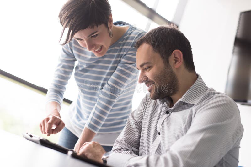 Two Business People Working With Tablet in startup office