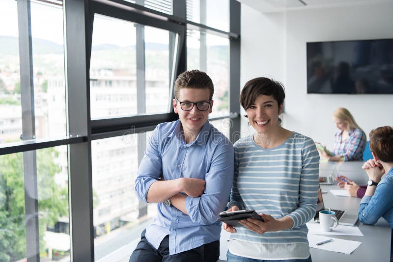 Two Business People Working With Tablet in office