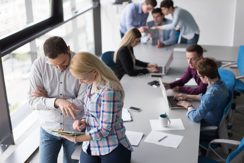 Two Business People Working With Tablet in office