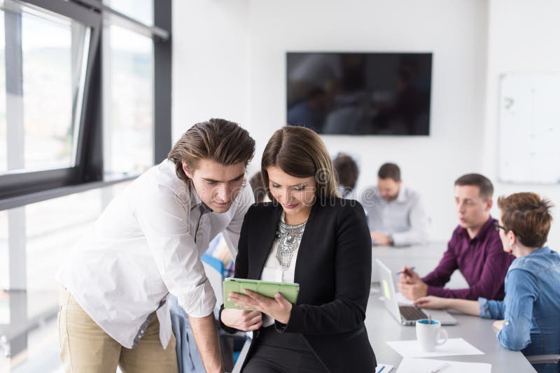 Two Business People Working With Tablet in office