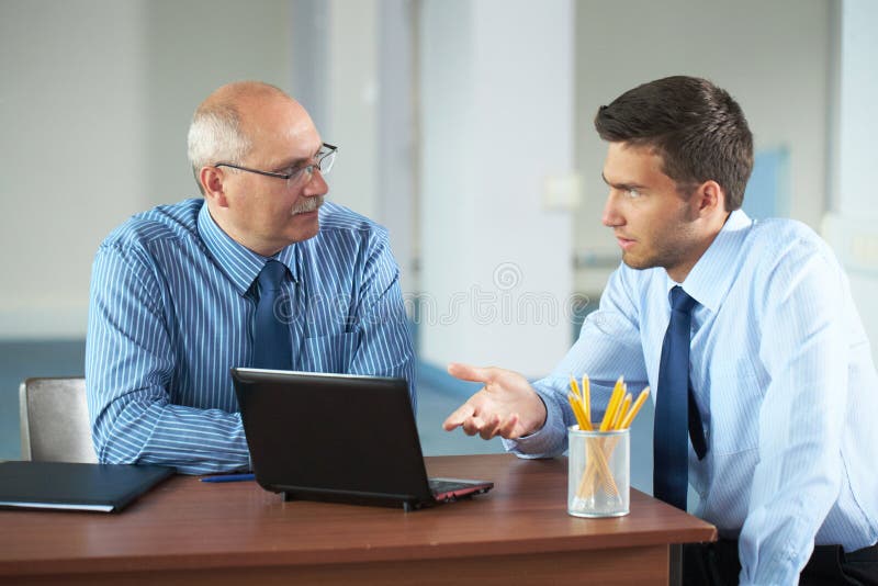 Two businessman with laptop, office shoot stock photos