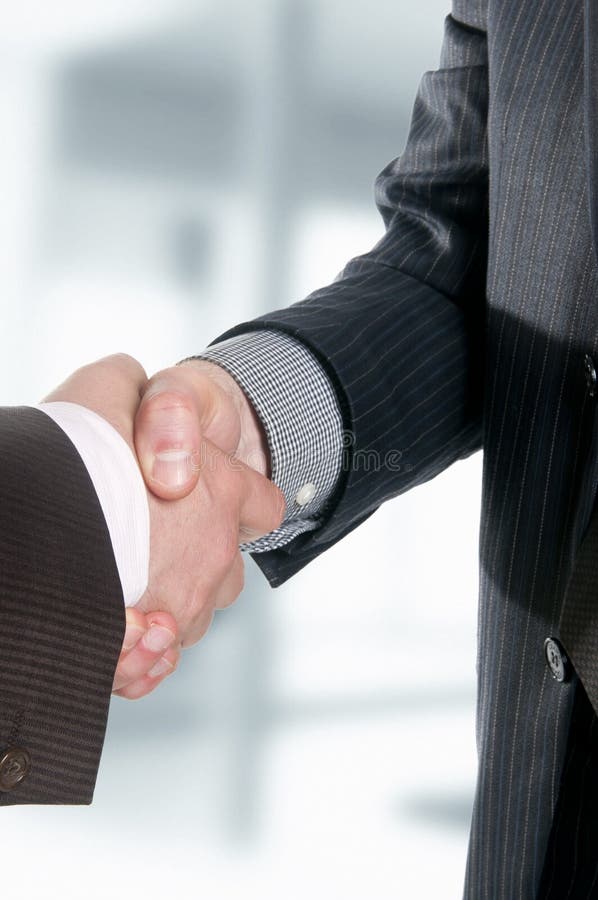 Two businessmen hands handshake