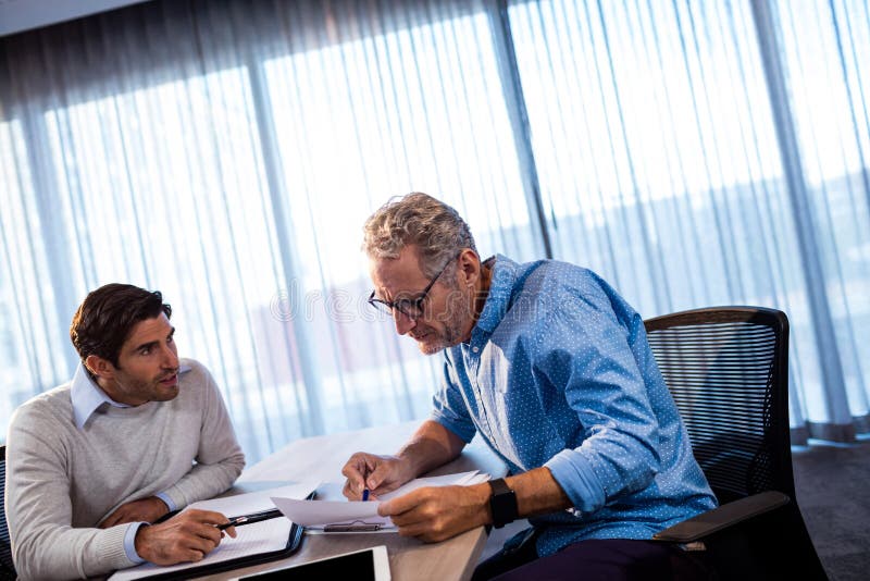 Two Concentrated Businessmen Working Together Stock Photo Image Of