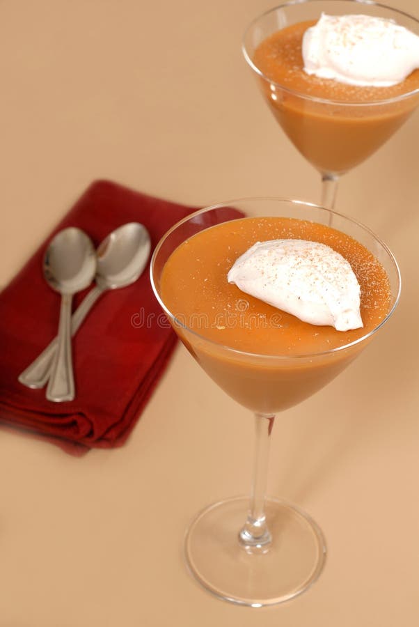 Two butterscotch puddings in martini glasses