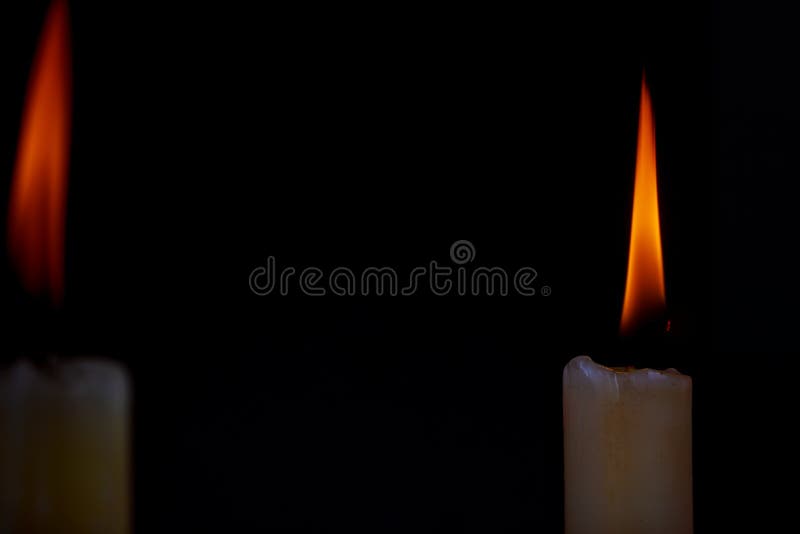 Two Light Candle Burning Brightly In The Black Background Stock Photo