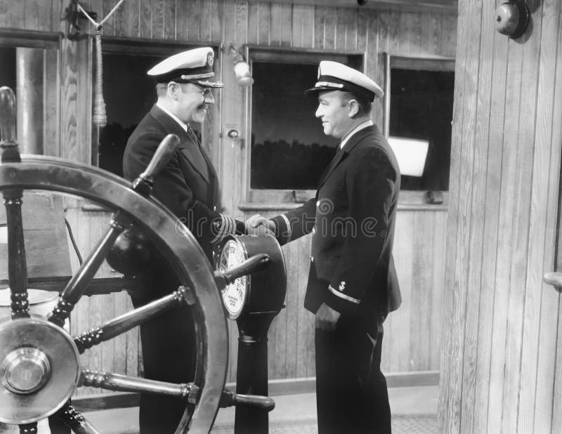 Two captains shaking hands on a boat