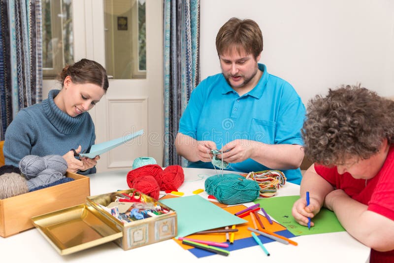 Two caretakers with a mentally disabled women making a Ergotherapy. Two caretakers with a mentally disabled women making a Ergotherapy