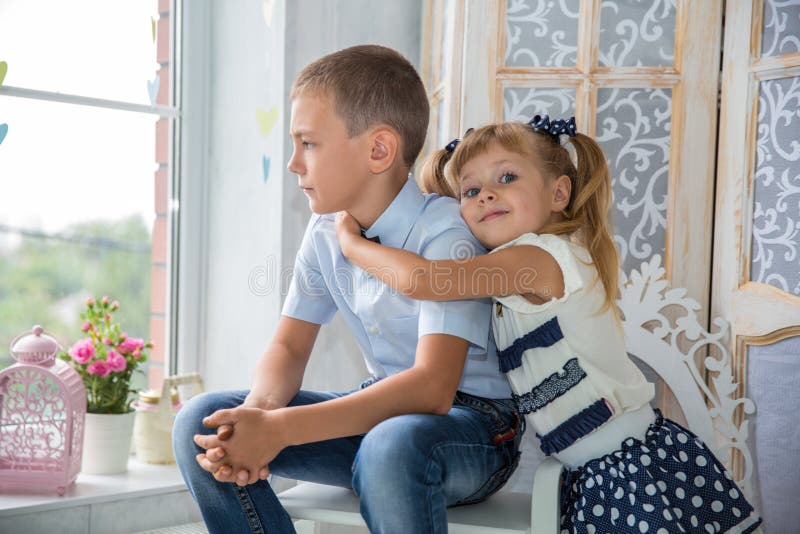 Two Caucasian siblings brother and sister posing. Girl and boy at photo shoot