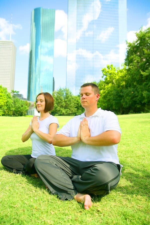 Two Caucasian Yoga In Downtown Park