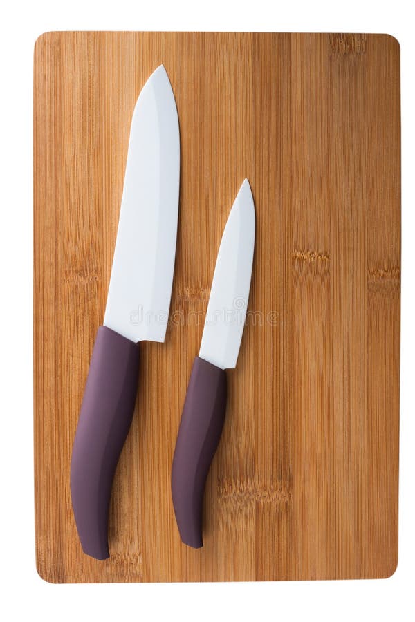 Two Ceramic Knife with a Purple Pen on Cutting Board. Stock Photo