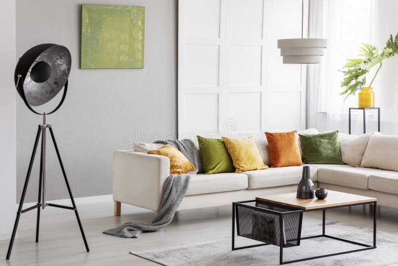 Two ceramic vases standing on modern coffee table in bright living room with elegant corner sofa, industrial lamp and golden lime stock photo Two ceramic vases standing on modern coffee table in bright living room with elegant corner sofa, industrial lamp and golden lime stock photo