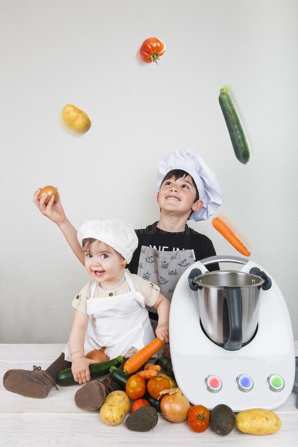 Two Children Cooking with a Futuristic Machine Stock Image Image of