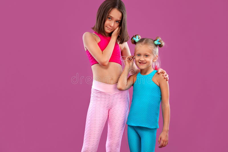 Two Children Girls Listen To Music on a Pink Background. Kids Lifestyle ...