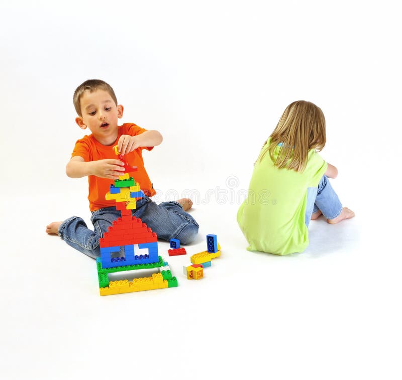 Two children playing with a constructor