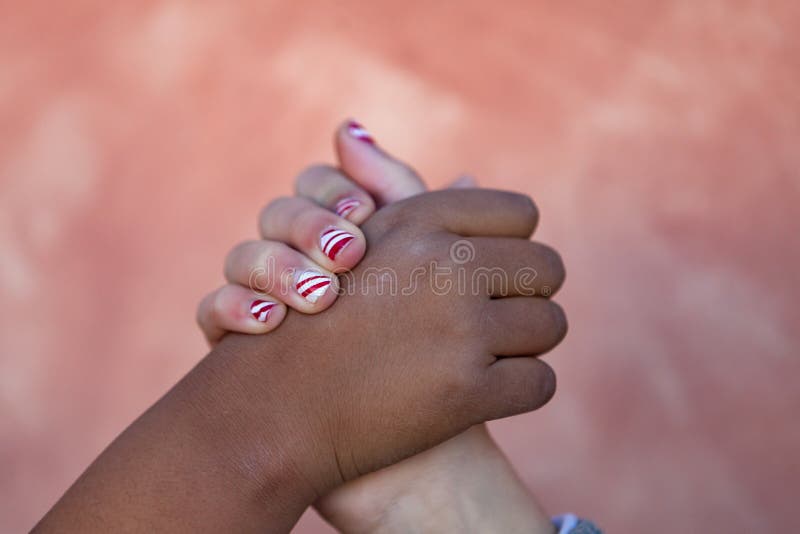 Two childrenÂ´s hands of differents races together