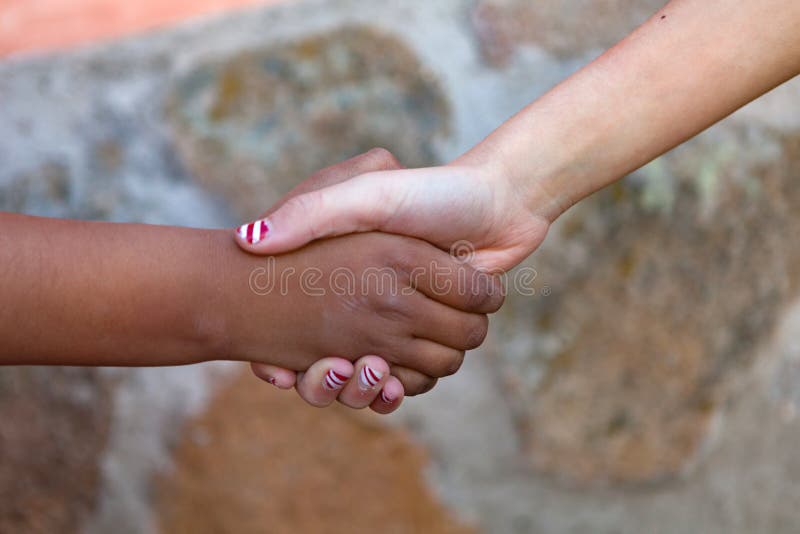 Two childrenÂ´s hands of differents races together