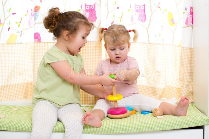 two children sisters play together cute indoor 47427354