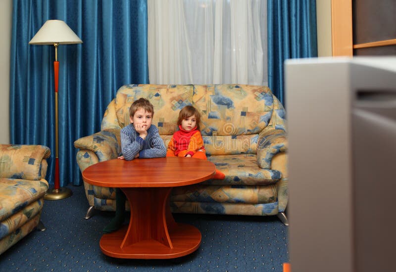 Two children watch tv