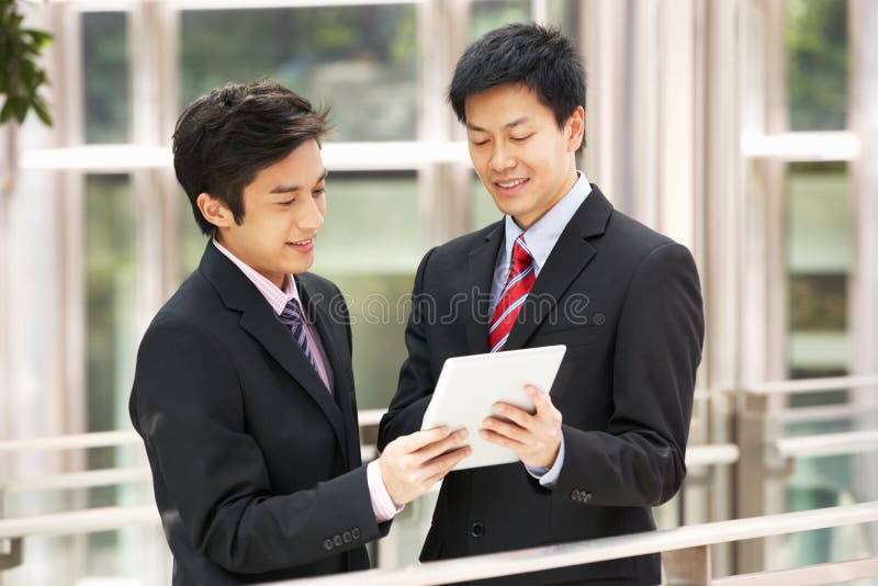 Two Chinese Businessmen Using Tablet Computer