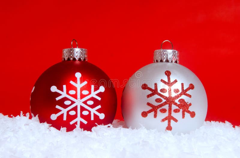 Two Christmas ornaments in snow