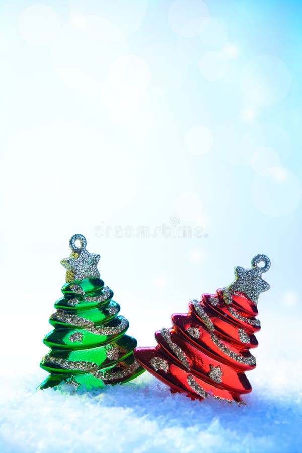 Two Christmas tree on white snow