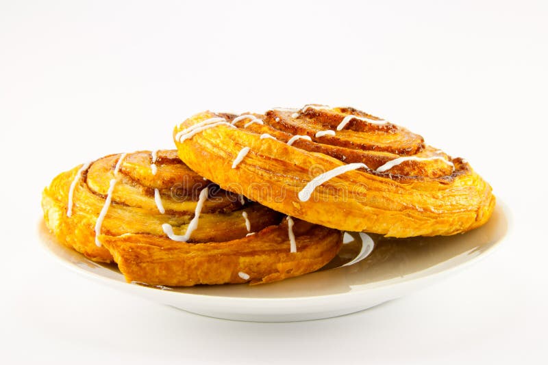 Two Cinnamon Buns on a White Plate