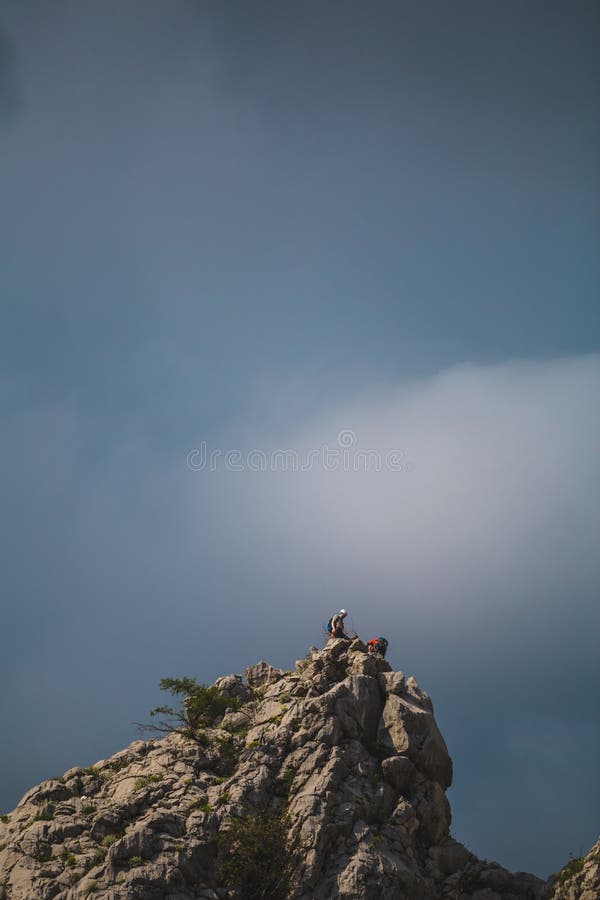 Two climbers climb to the top of the mountain royalty free stock photo Two climbers climb to the top of the mountain royalty free stock photo