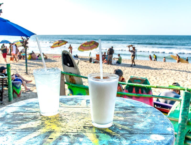 Two cocktails on a sun table with view of Mexican beach in Sayulita royalty free stock image Two cocktails on a sun table with view of Mexican beach in Sayulita royalty free stock image