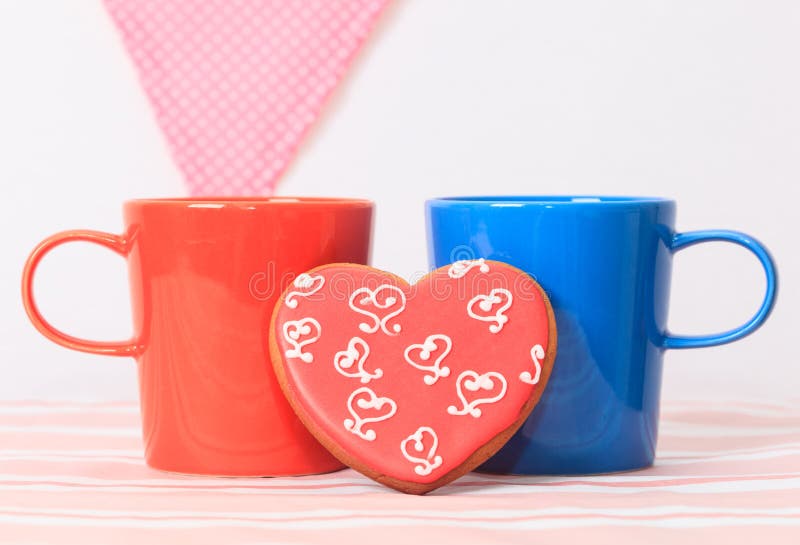 Two coffee cups and heart cookies