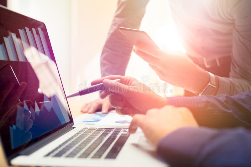 Two colleagues working on new global financial strategy plan using laptop and smartphone.Modern business team innovation royalty free stock image Two colleagues working on new global financial strategy plan using laptop and smartphone.Modern business team innovation royalty free stock image