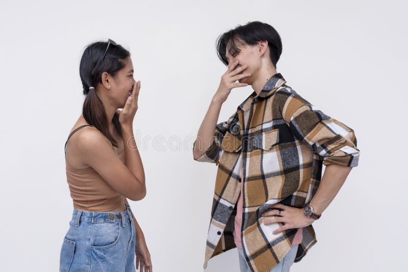Two college students having a casual lighthearted conversation. One Filipina lady and one chinese guy telling jokes. Is. royalty free stock image