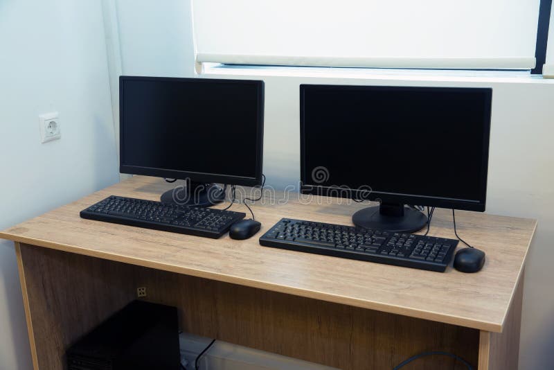 Two Computers and a Desk . Keyboard and Mouse . Two Computer