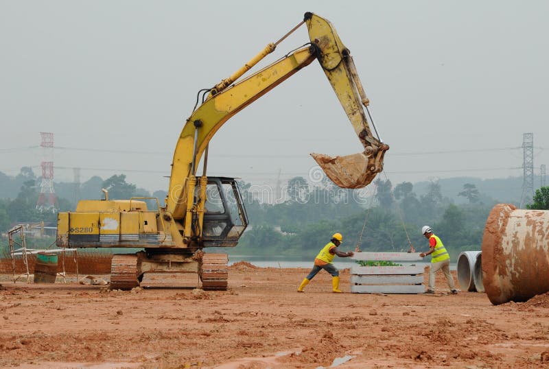 Two Construction Workers Lifting Concrete Slab Using the Excavator ...