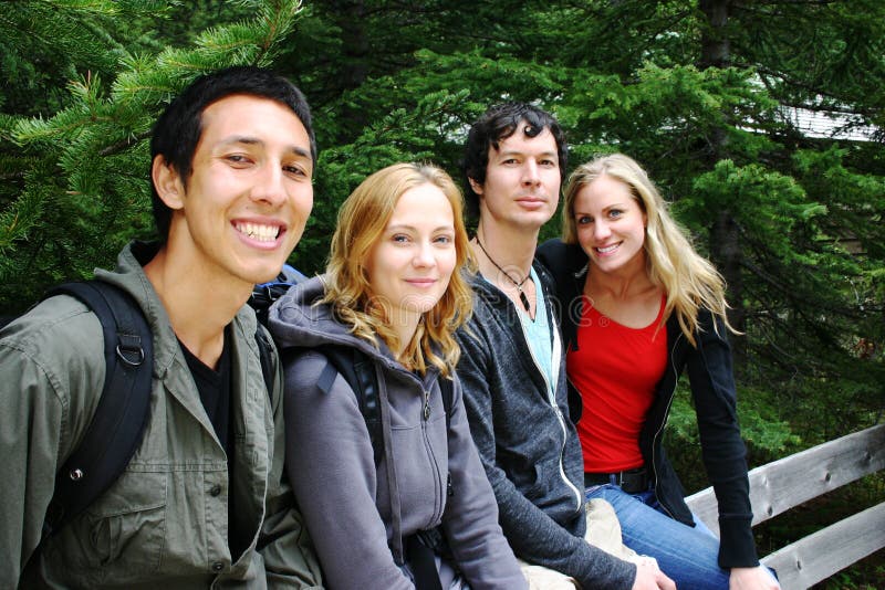 Two couples taking a rest while hiking. Two couples taking a rest while hiking